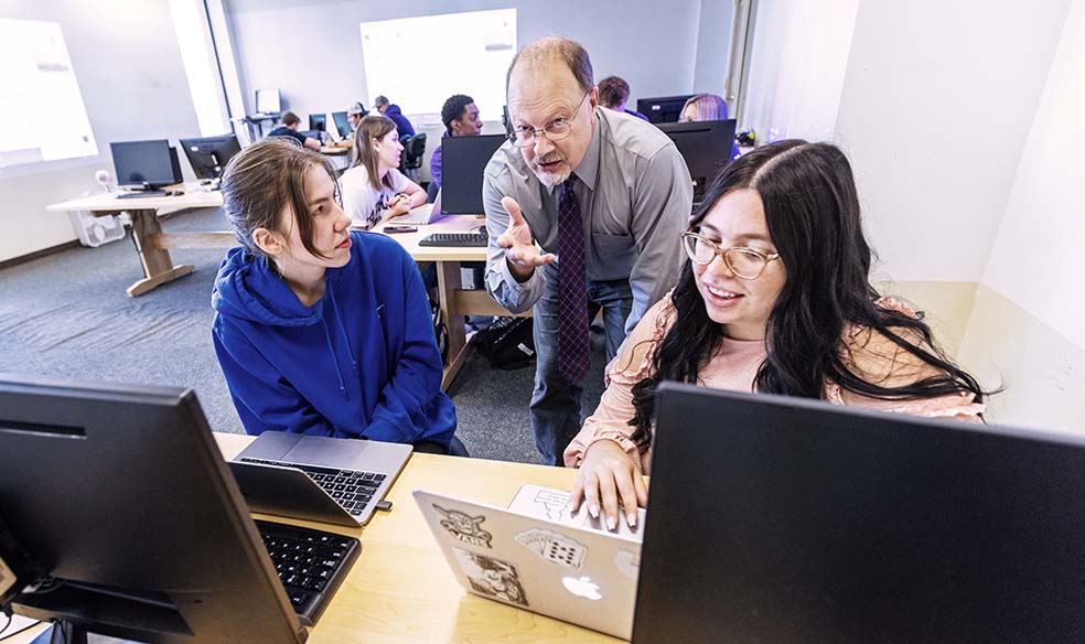 Faculty member talking with students