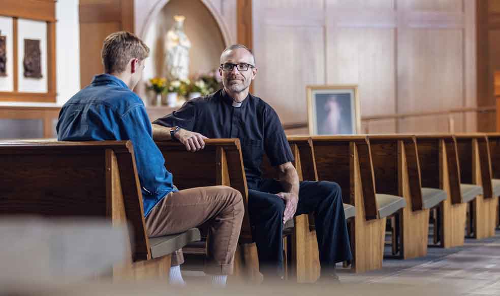 Priest in Chapel with Student