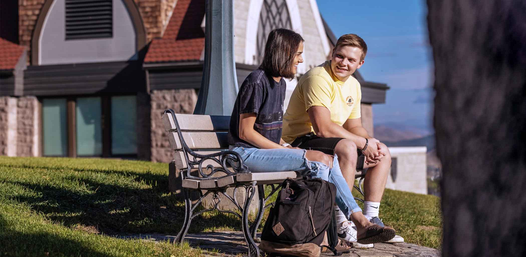 Students on bench outside All Saints Chapel