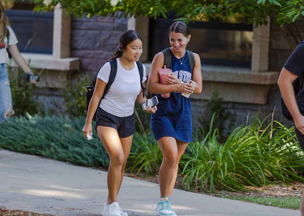 Two students walking outside
