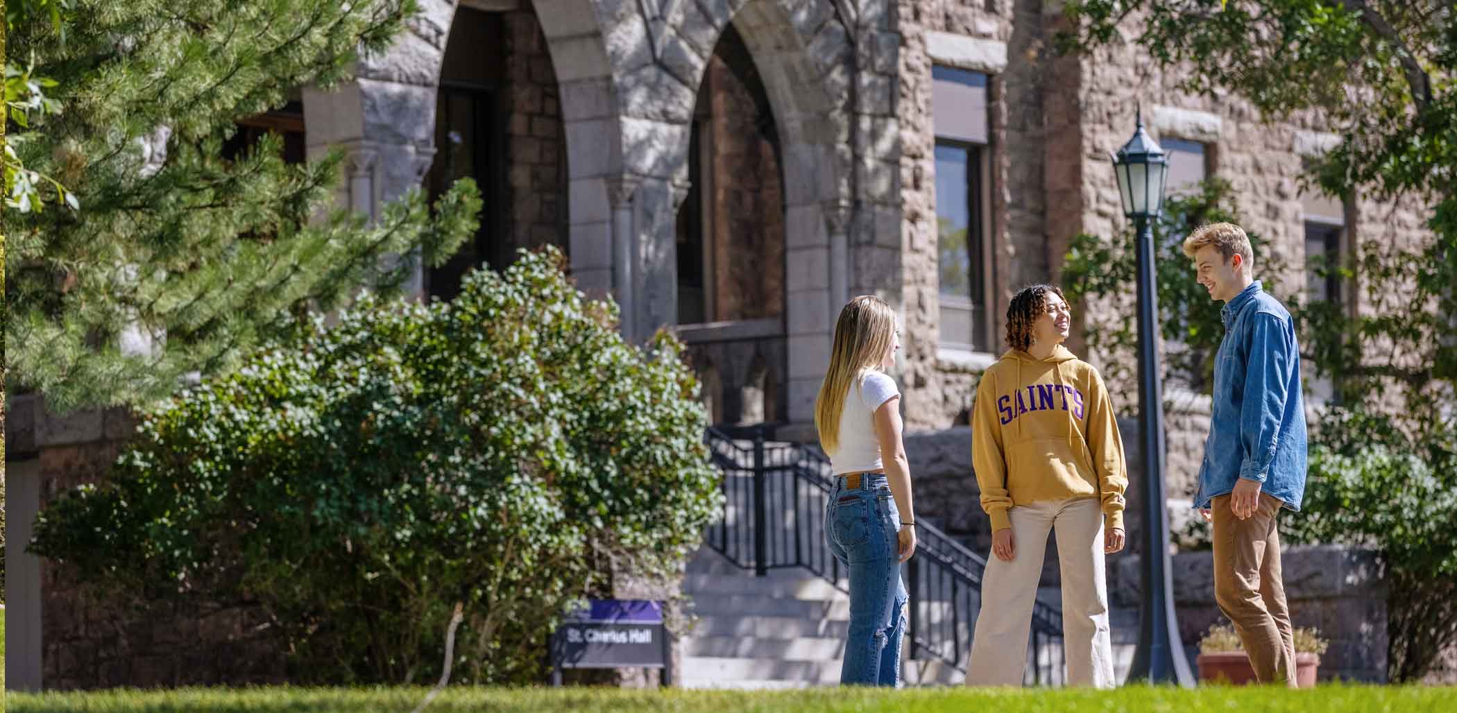 Three Students in front of St. Charles