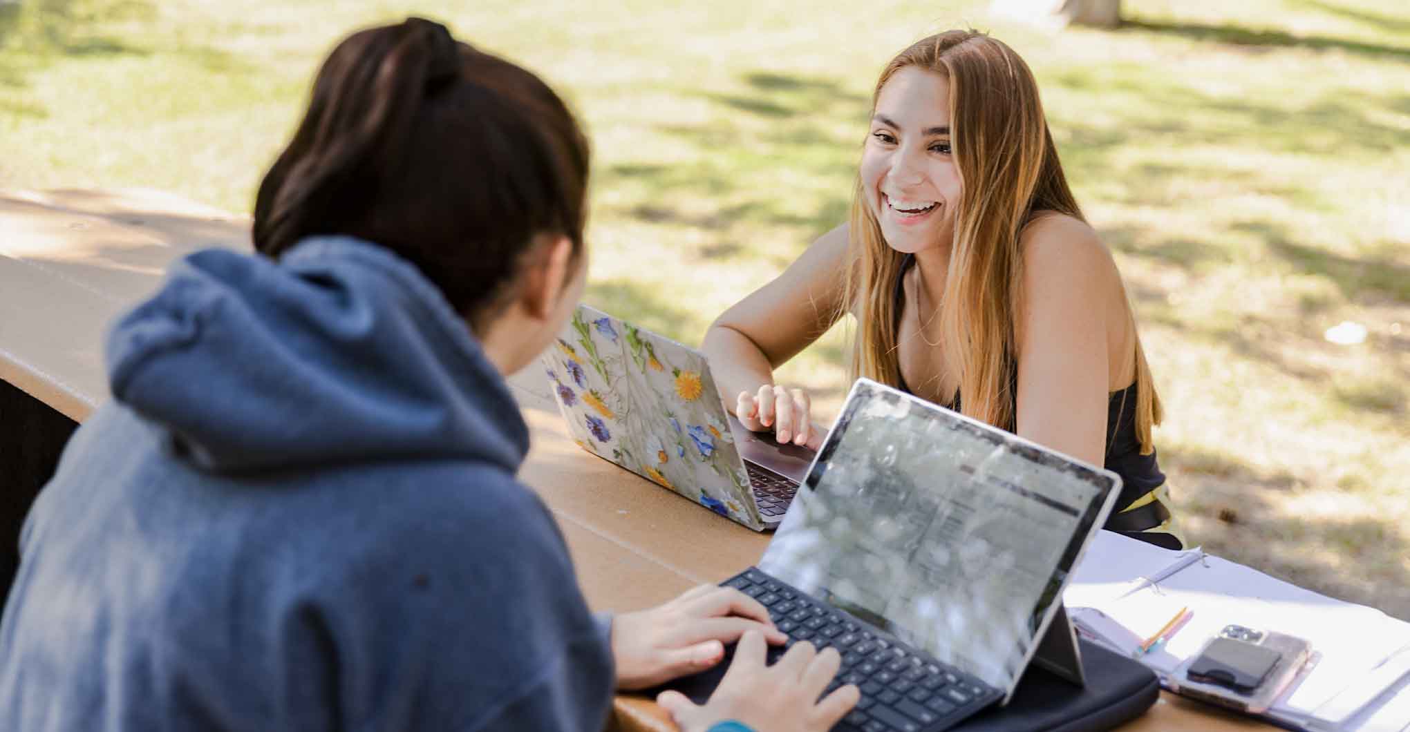 Two Female students outside studying