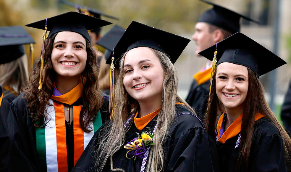 Three Female Graduates at Commencement