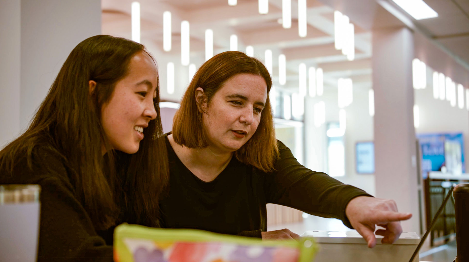 Rachel Martin with Student in Library