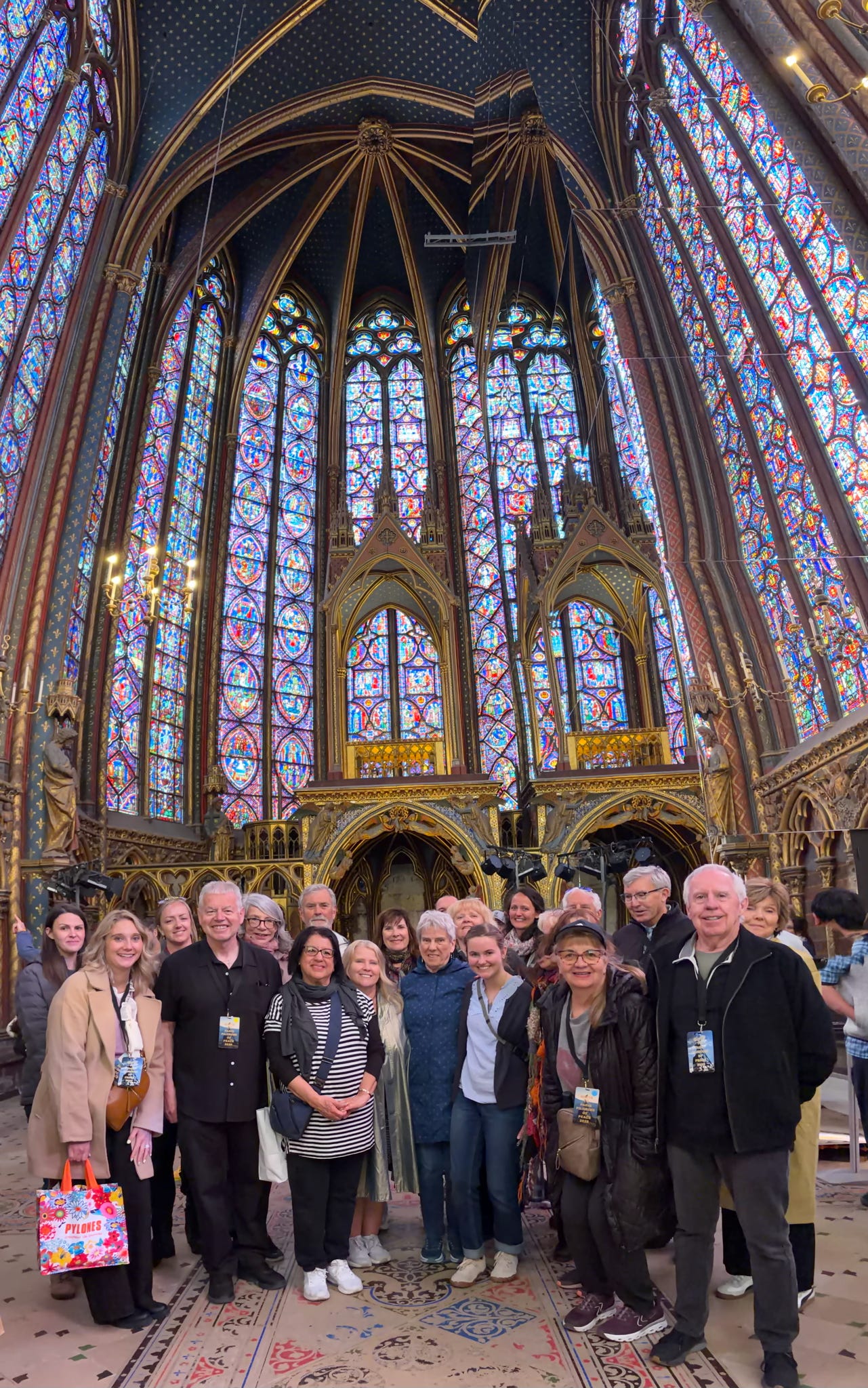 Maria, Father Beretta, and a small group of pilgrims inside Sainte-Chapelle in Paris