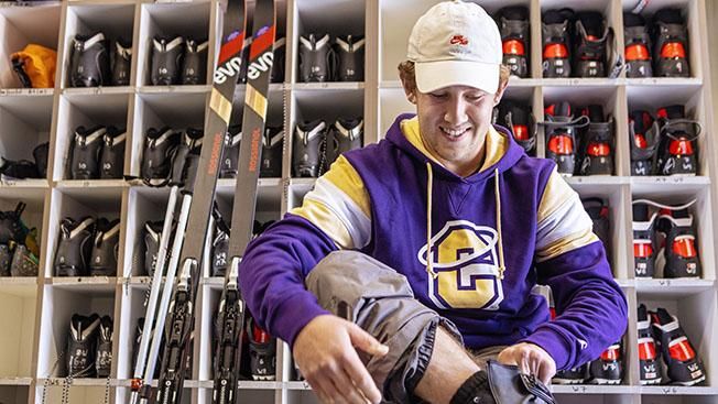 Student putting on ski boots