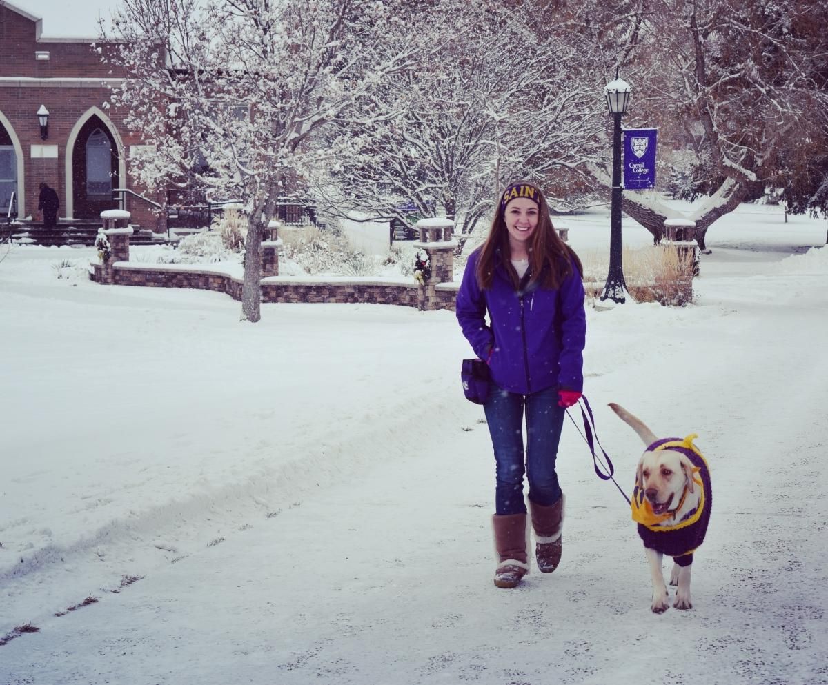 Breanna walking Anna in the snow on campus