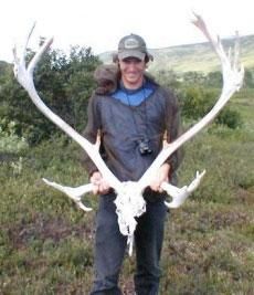 Andy Brown holding an elk skull and antlers