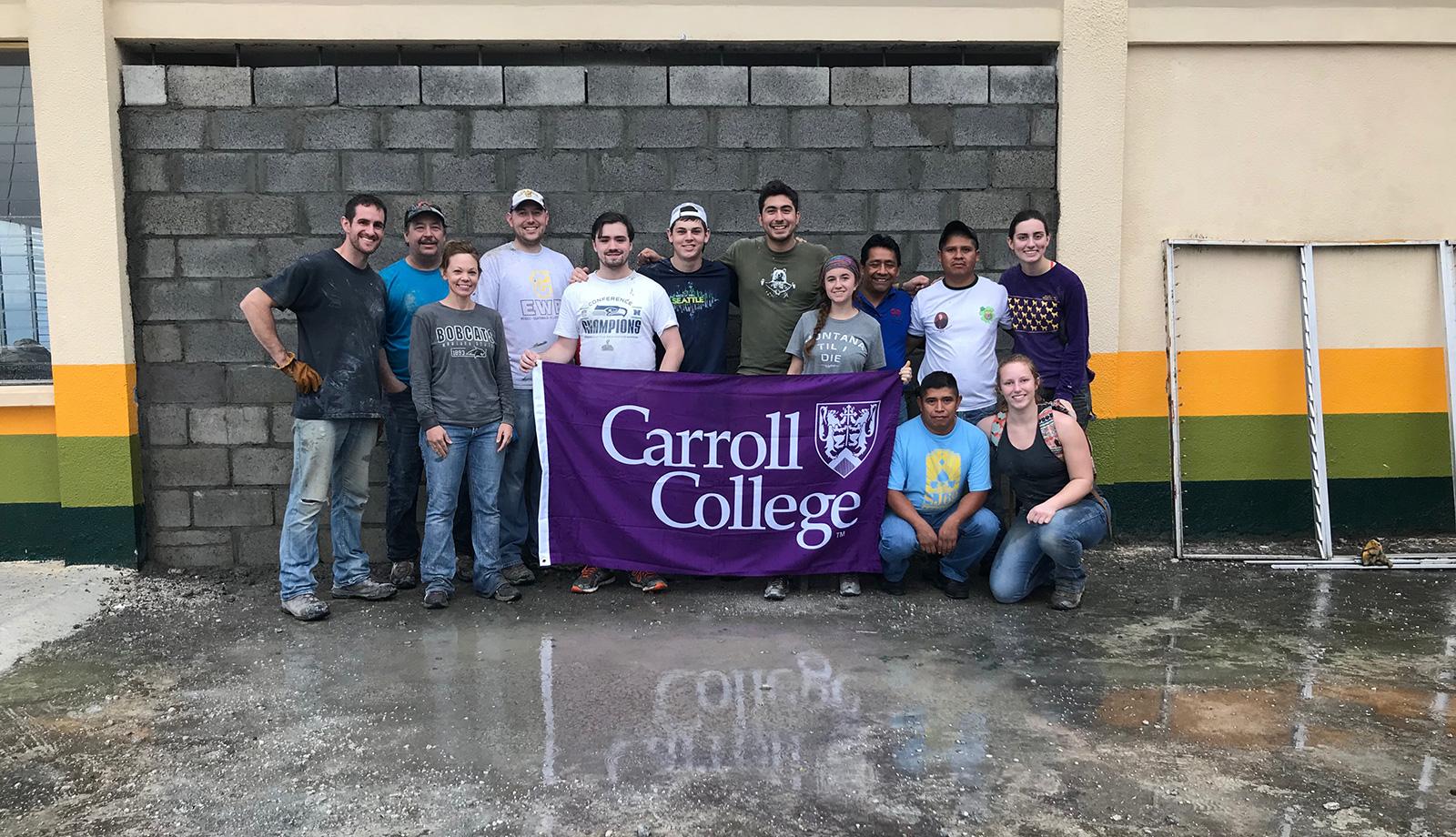 EWB Team in Guatemala holding a Carroll College Flag