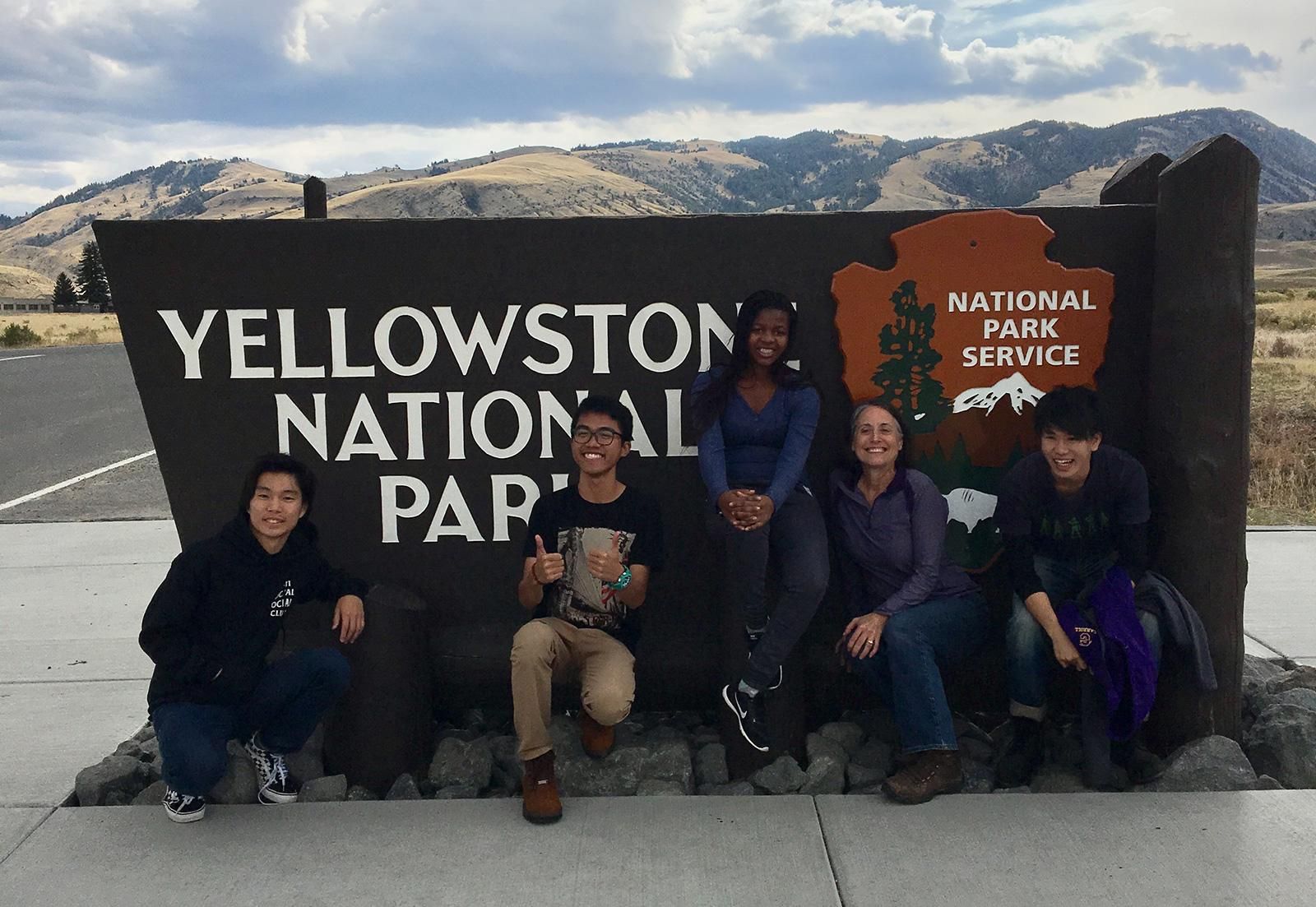 Exchange students pose in front of Yellowstone National Park sign