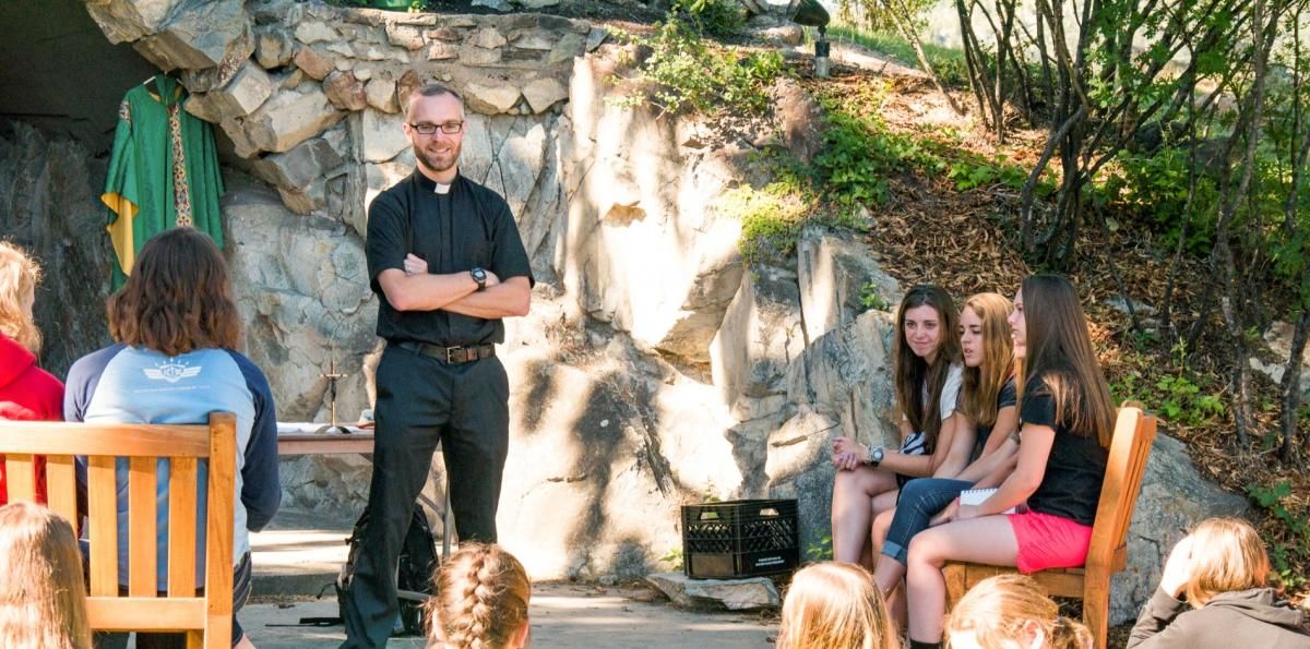 Students and Marc Lenneman in the Kateri Grotto