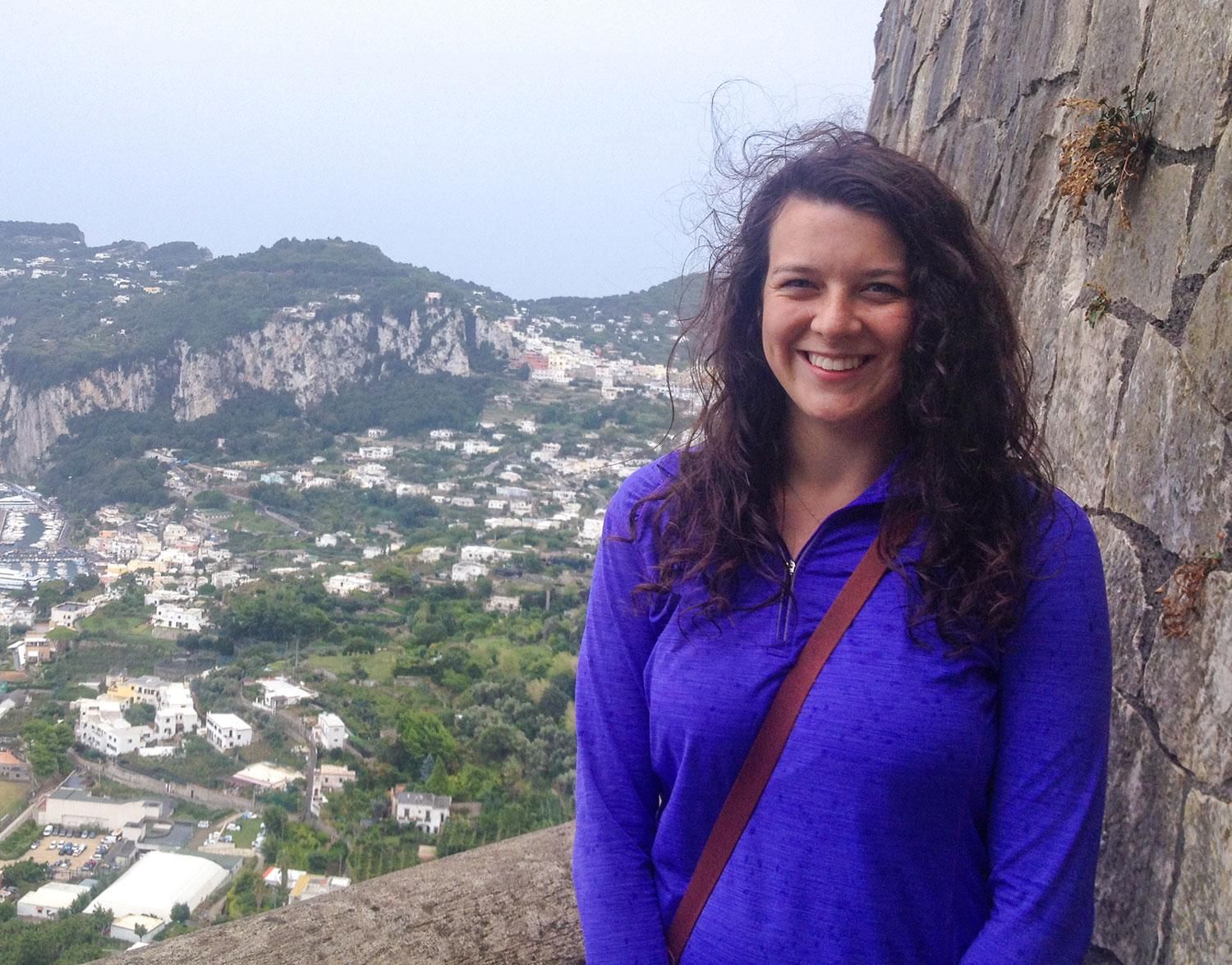 Portrait of Jessica Knapp with a view of a village in the background