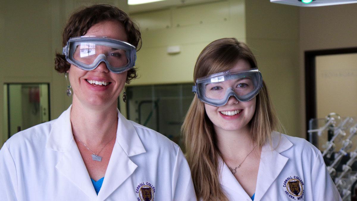 Dr. Carolyn Pharr and Meghan Benda wearing lab coats and eye protection