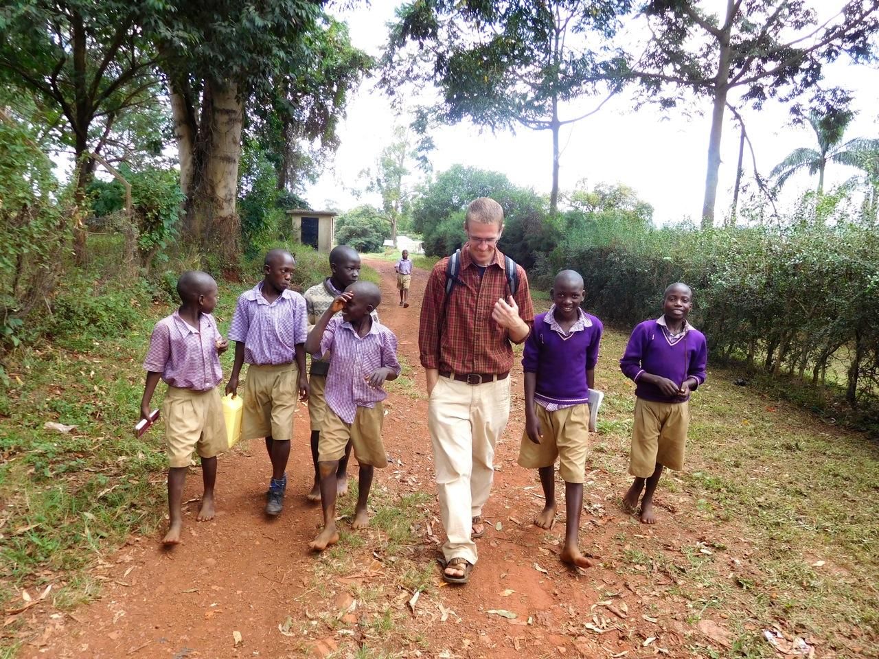 Alex Woelkers walking with young students abroad