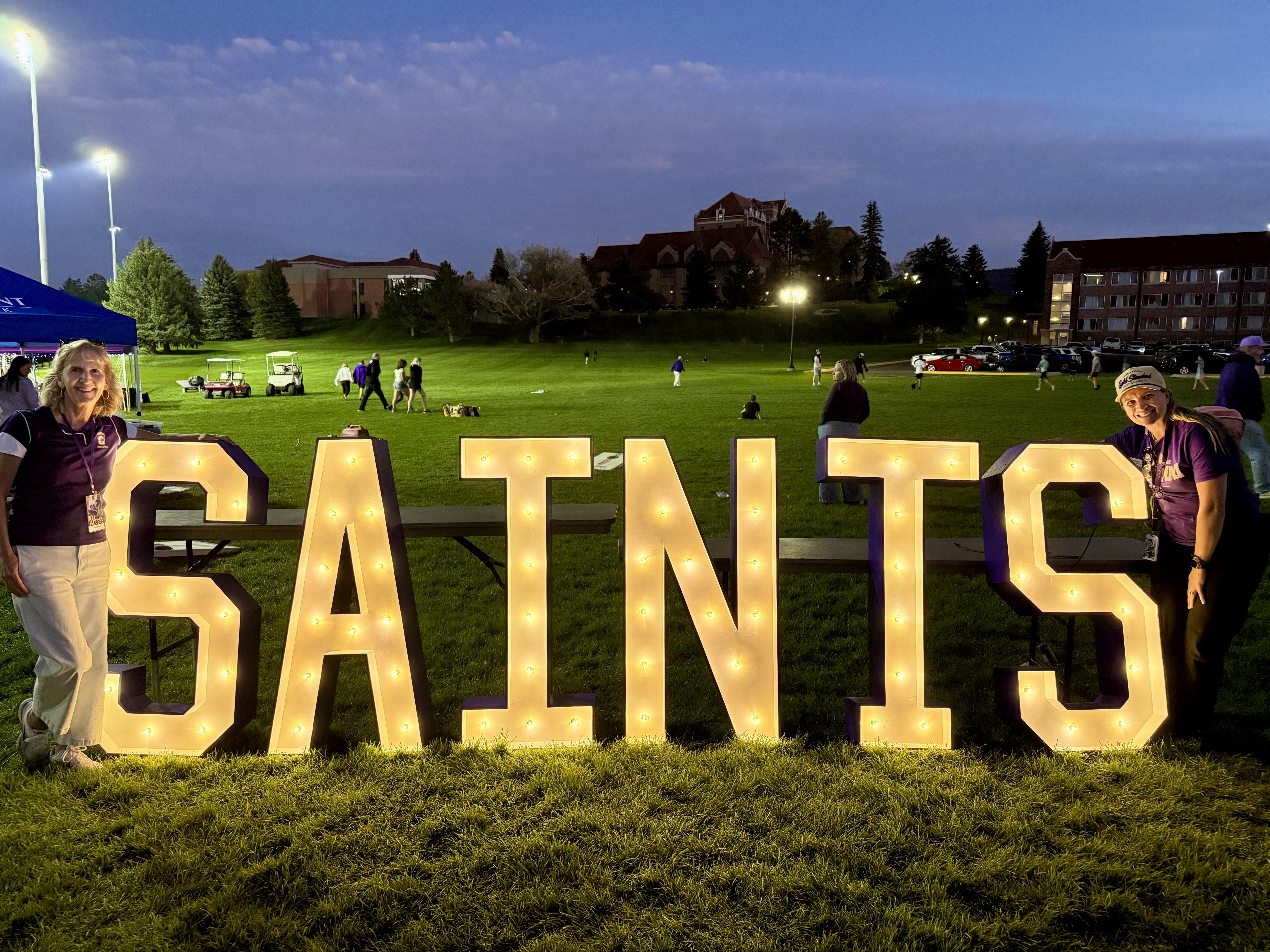 Renee and Beth with Saints sign